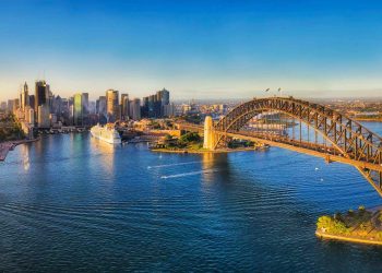 RN323Y Warm and soft morning sun light on major Sydney city CBD Landmarks around Sydney harbour viewed from above - aerial wide panorama facing Cicrular Quay